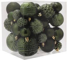 a bunch of green ornaments in a clear box