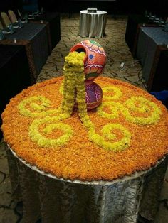 an elaborately decorated table with flowers and vases in the shape of letters on it