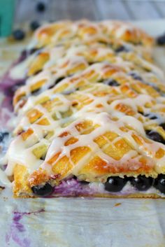 a blueberry pie with white icing on it