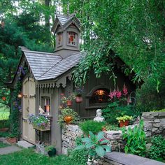 a small house made out of rocks and plants