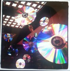 several cds are being held up in the air with their lids open and on top of each other