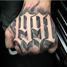 a man's hand with the word hell tattooed on it