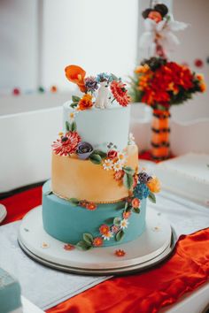 a multi - tiered wedding cake with flowers on it