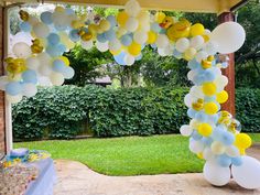 an outdoor party with balloons and streamers