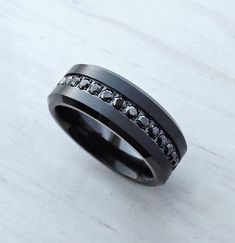 a black ring with white diamonds on it