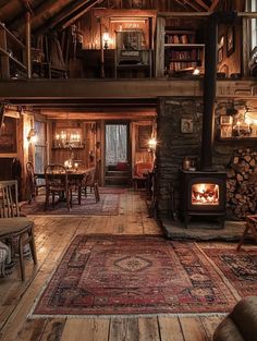 a living room filled with furniture and a fire place in the middle of a wooden floor