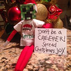 a sign that says don't be a creeper spread christmas joy next to an elf