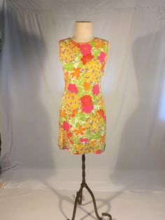 "vintage 1960s mini dress an Original Gary Jay California ILGWU Union tag multi-color floral print cut out circles at waist sides boat neck zip up back sleeveless lined fabric feels cotton or blend, lining feels acetate custom added green felt side skirt panels a few small marks/a small tethered neck trim area measures, lying flat, shoulder-14\" chest-17\" waist at top of cut out circle-16\" waist at bottom of cut out circle-15\" hip-19\" total length-34 1/2\"     We do not offer returns or refunds unless something is grossly misrepresented. Please contact us within 2 business days of receiving to discuss any possible returns for this reason. We do not offer refunds for your shipping fees. Please feel free to contact us with any questions you may have about an item prior to purchase and we 60s Gogo Dress, Groovy Fitted Floral Print Dresses, 1970s Style Mini Summer Dress, Retro Multicolor Lined Mini Dress, Retro Fitted Floral Print Mini Dress, Vintage Fitted Printed Mini Dress, Vintage Sleeveless Mini Dress With Floral Print, Fitted Vintage Printed Mini Dress, Retro Fitted Mini Dress With Floral Print