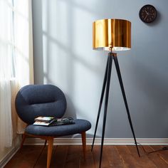 a floor lamp next to a chair in a room