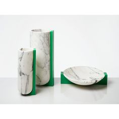 two marble vases sitting next to each other on a table