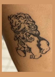 a tattoo on the leg of a person with a lion design on it's arm