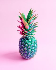 a colorful pineapple on a pink background