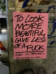 a pink sign that says to look more beautiful give less affick written on it