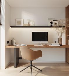 a desk with a computer on top of it in front of a bookshelf