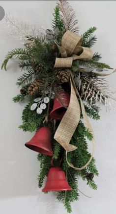 a christmas wreath with bells and pine cones