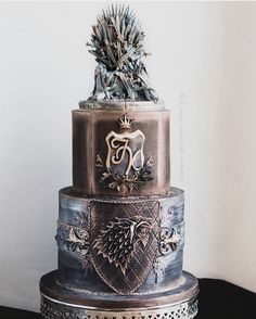 a three tiered cake decorated with metal decorations