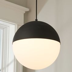 a black and white light hanging from a ceiling