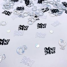 lots of silver and black stickers that say miss and mrs on white paper with the word mr and mrs in large letters