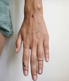 a person with a small tattoo on their left hand