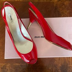 Authentic Miumiu Brand New, Never Worn Tried Indoors Only Sling Back Peep Toe Red Patent Leather Upper Red And Gold, Slim, Cone Heel Made In Italy Dust Bags And Box Included Elegant Miu Miu Slingback Pumps With Pointed Toe, Chic Miu Miu Slingback Pumps With Heel Strap, Miu Miu Slingback Heels With Heel Strap, Miu Miu Leather Slingback Pumps For Evening, Red Slingback Pumps With Red Sole And Open Heel, Red Slingback Pumps With Open Heel And Red Sole, Red Slingback Pumps With Open Heel, Red Open Heel Slingback Pumps With Red Sole, Elegant Miu Miu Leather Slingback Pumps