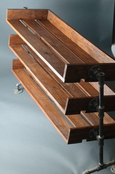 a wooden bench sitting on top of a metal pipe