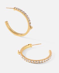 Slim lines and glittering stones give these hoop earrings a surprising dose of effortless glamor and contemporary luxury, fashioned into a subversive-basic design. Keep it casual and cool with a pair of classic hoops upgraded for your modern lifestyle.
 
Size: 3×33mm
Stone Color: Shiny White
Material: Crystals, 18k Gold Plated On Brass Trendy Sparkling Hoop Earrings, Modern Hoop Earrings With Plating For Anniversary, Everyday Hoop Earrings With Sparkling Stones, Modern Hoop Earrings With Sparkling Stones, Elegant Hoop Earrings With Sparkling Stones For Everyday, Sparkling Stones Hoop Earrings, Elegant Everyday Hoop Earrings With Sparkling Stones, Everyday Elegant Hoop Earrings With Sparkling Stones, Glamorous Small Hoop Earrings As Gift