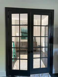 the black double doors are open and ready to be used as a bed room divider