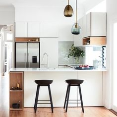 two stools are in front of the kitchen island