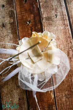 a small white flower on top of a wooden table