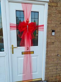 a white door with a red bow on it