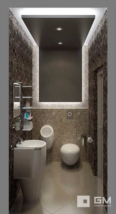 a modern bathroom with two sinks and a toilet in the center is lit by recessed lighting