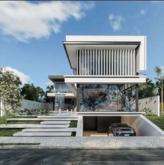 a car is parked in front of a modern house with stairs leading up to it