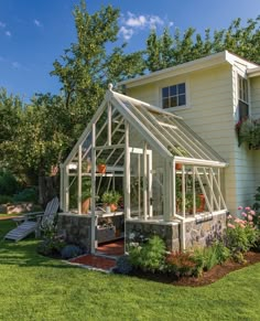 a house with a small greenhouse in the front yard