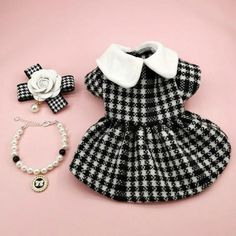 a black and white checkered dress with matching bracelet, necklace and flower brooch