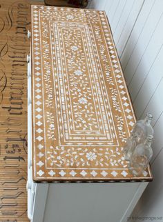 a wooden table with white and brown designs on it