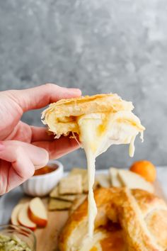 a person is dipping cheese on some bread