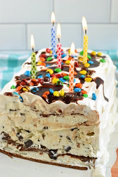 a birthday cake with lit candles on it