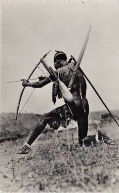 an old black and white photo of two men with arrows