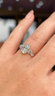 a woman's hand with a diamond ring on it