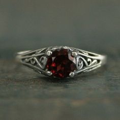 Garnet Engagement Cinderella Ring with Garnet Vintage Style Ring Red Stone Ring Garnet Ring Genuine Mozambique Garnet Antique Style Ring"If you keep on believing, the dream that you wish will come true"Cinderella sparks memories of glass slippers, fairy god mothers, and dancing until midnight. This is her ring...dainty, intricate and as stunning as can be! A detailed filigree setting securely holds a 5mm Genuine Mozambique Garnet. It is surrounded by intricate vining filigree. The top of the ste Classic Garnet Round Band Rings, Classic Garnet Ring With Round Band, Red Solitaire Promise Ring, Red Solitaire Ring For Promise, Classic Red Crystal Ring As A Gift, Classic Red Crystal Ring For Anniversary, Classic Red Crystal Ring Gift, Classic Red Crystal Ring For Gift, Red Garnet Promise Jewelry