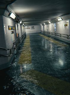 an empty subway station with benches and lights