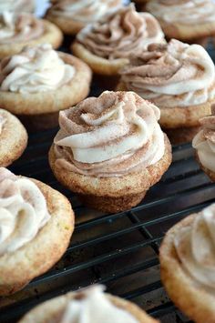 cupcakes with frosting sitting on a cooling rack