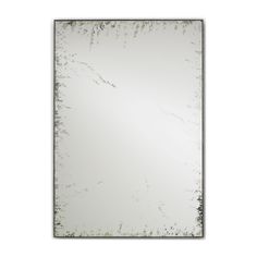 a mirror that is sitting on top of a table with a white wall in the background