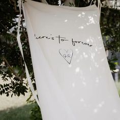 there's to forever written on a white towel hanging from a tree