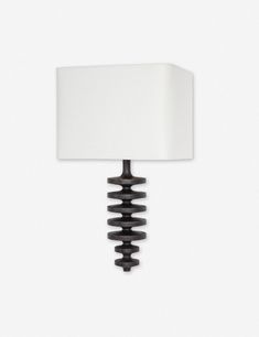 a wall lamp with a white shade on it