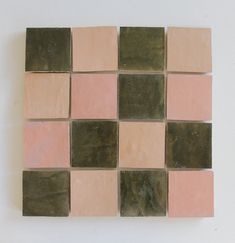 a tile wall with different colored squares on it