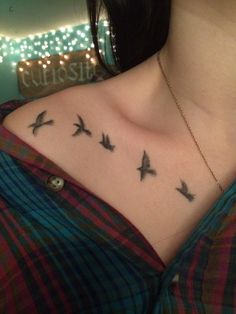 a woman's chest with birds on it