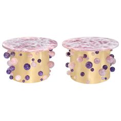 two tables with pink and purple stones on them