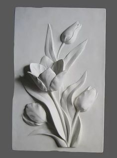 a white paper sculpture with flowers on it