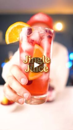 a person holding up a glass filled with fruit